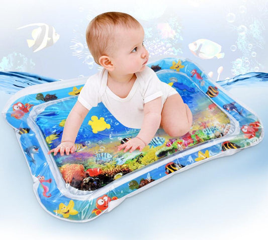 Baby playing on inflatable water mat with ocean animals