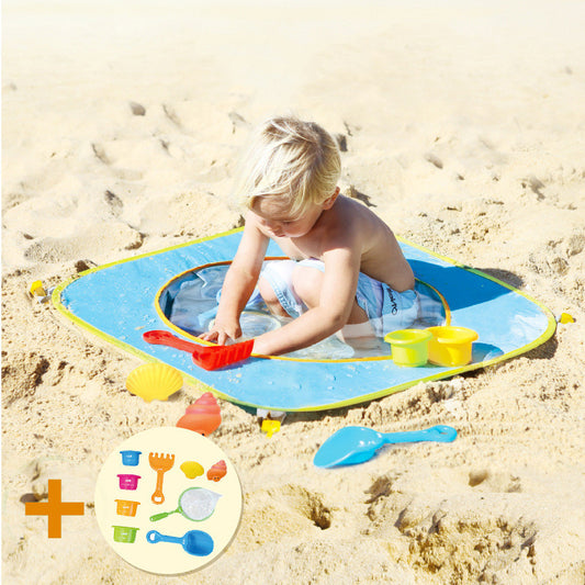 Child playing on a blue water pocket mat with beach toys