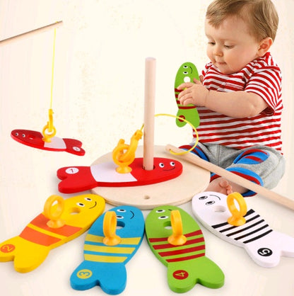 Toddler playing with wooden fishing toy game set
