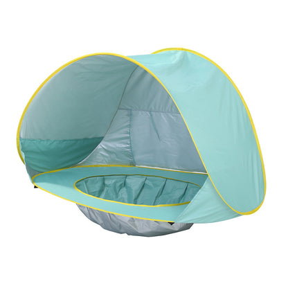 Pop-up baby beach tent with mini pool, UPF 50+ sun protection, waterproof play zone for toddlers on the beach.